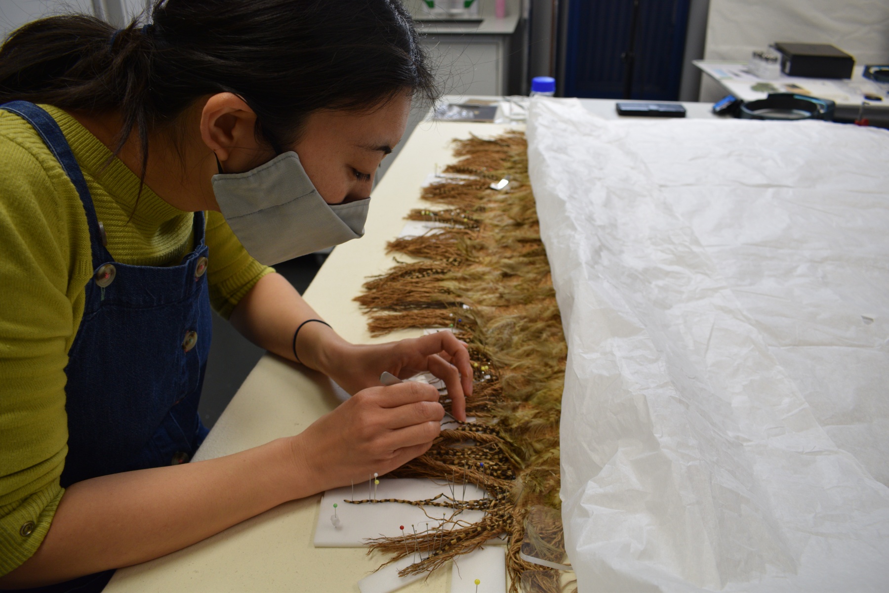 Misa Tamura works on the cloak.JPG