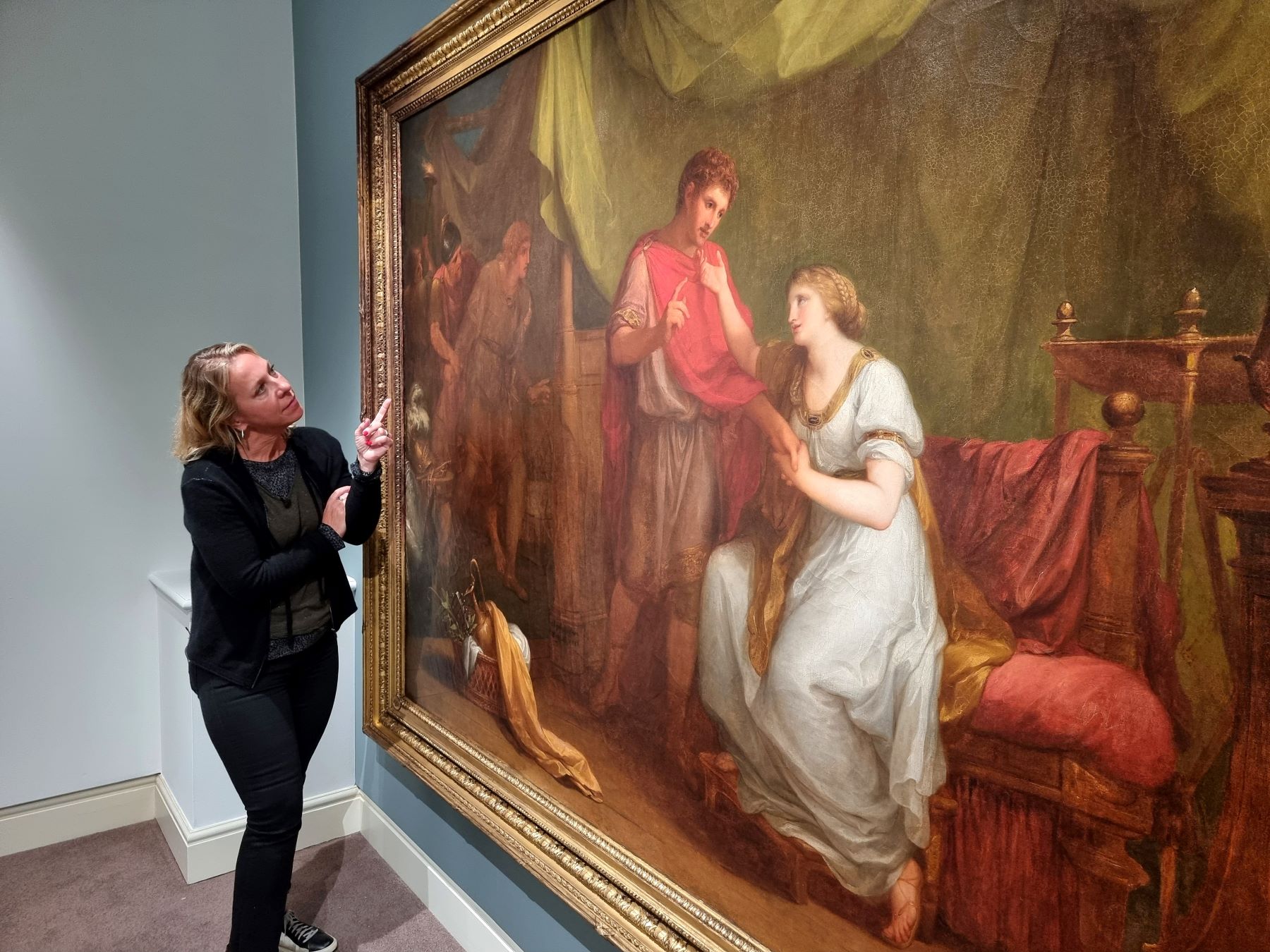 Conservator Sophie Reddington with conserved Diomedes and Cressida painting at Petworth - National Trust, Michael Cole.jpg