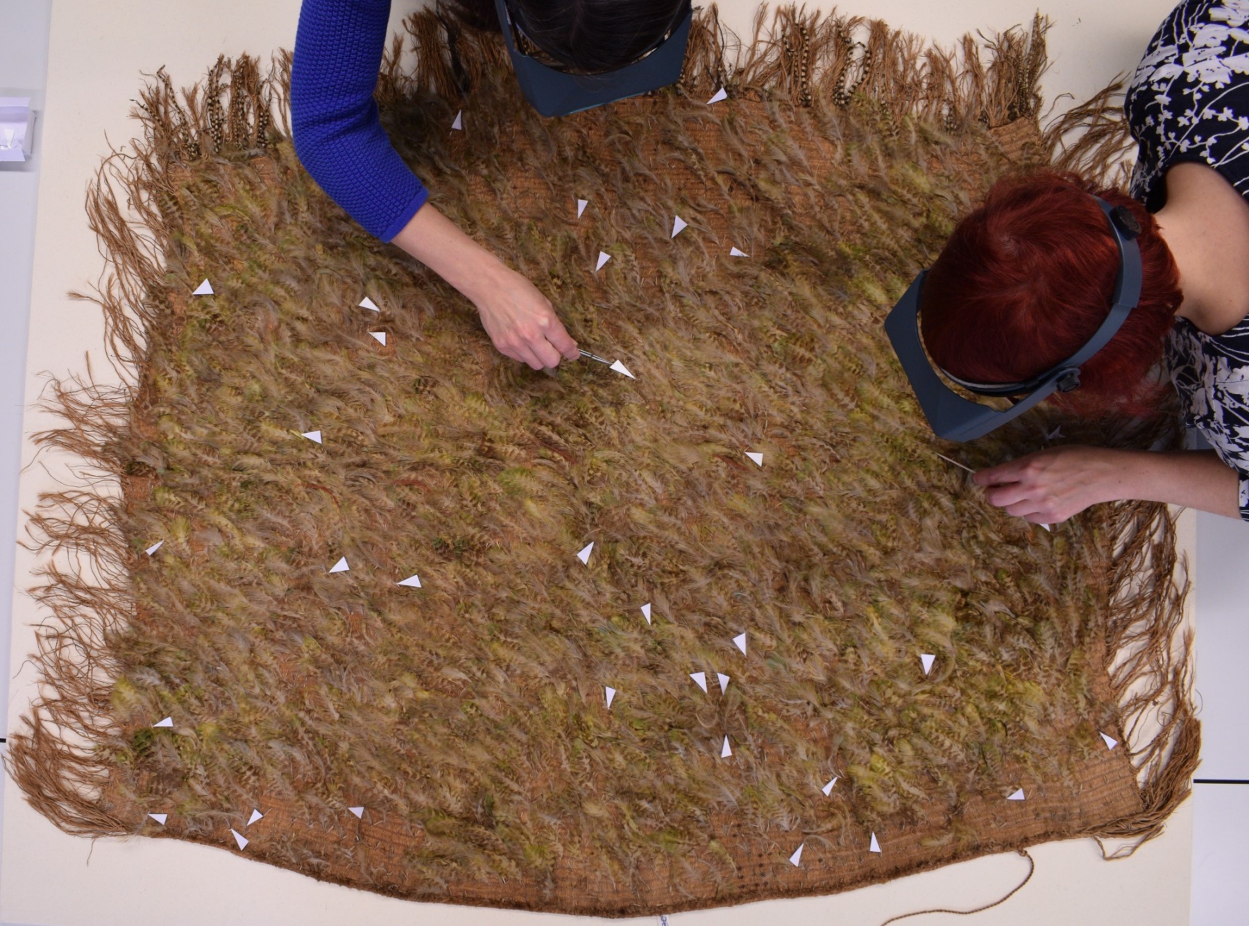 Nicole Rode (left) and Anna Zwagerman (right) carry out work on the cloak.jpg