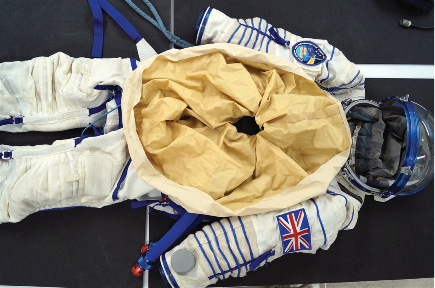 Sokol suit with chest opening visible. The fabric is gathered together and secured with a rubber band during spaceflight.png